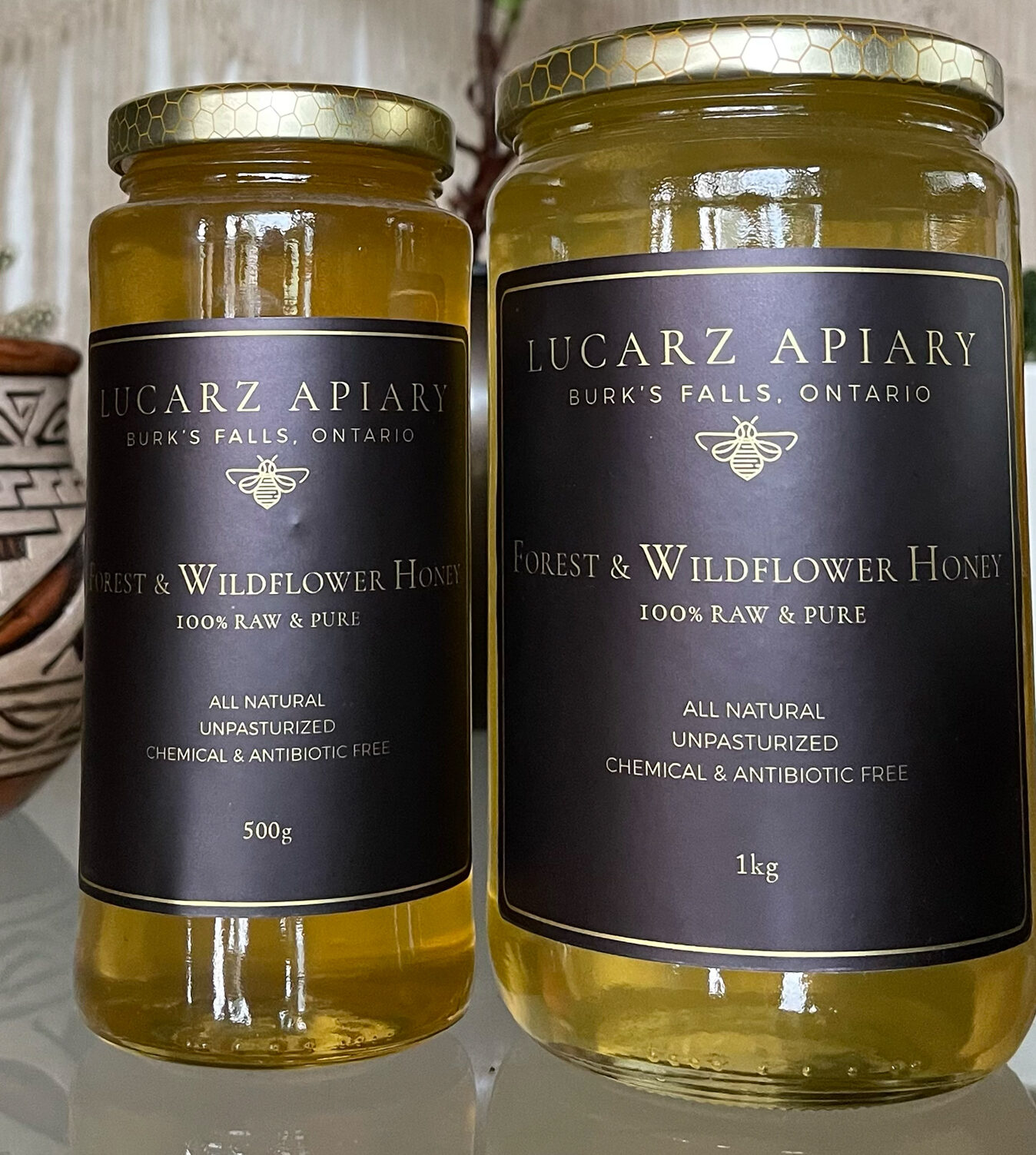 500g and 1kg jars of Lucarz Apiary forest and wildflower honey